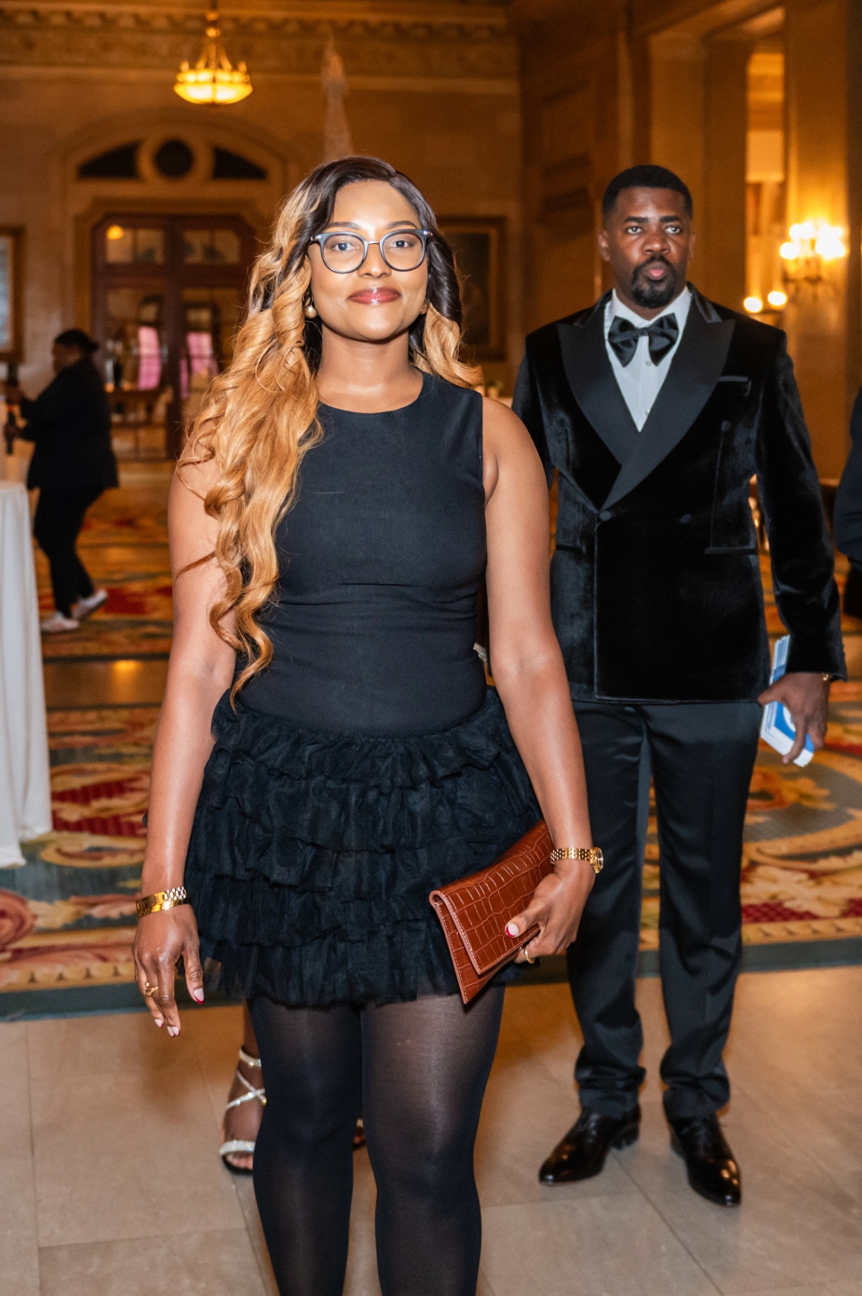 Couple in black formal attire entering the gala reception