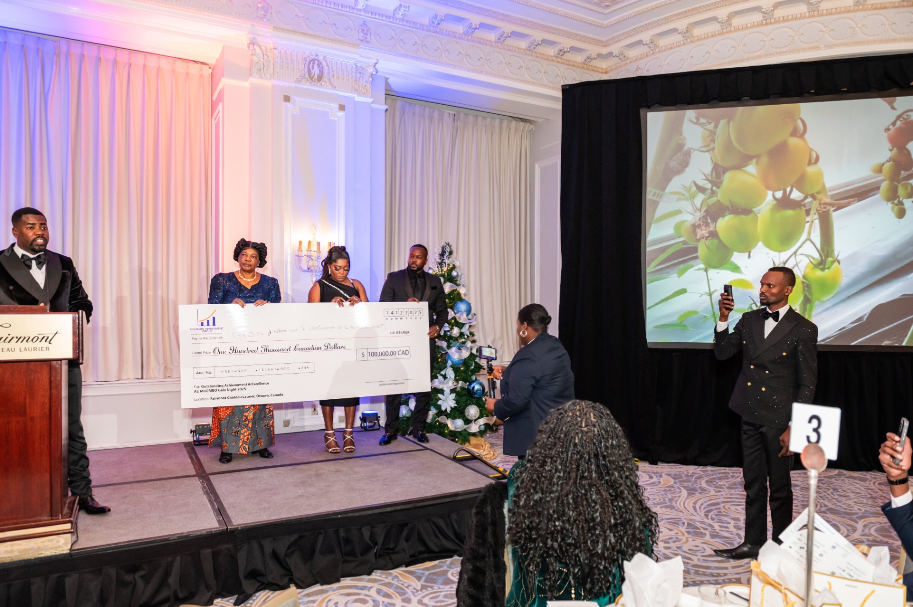GADEF accepting the CA$100,000 Grand Prize at MBOMBO Gala Night 2025