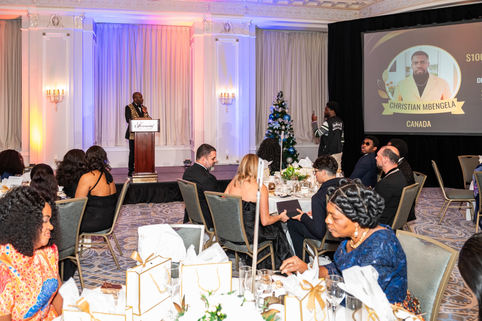 Host announcing the Christian Mbengela CA$100,000 Grand Prize