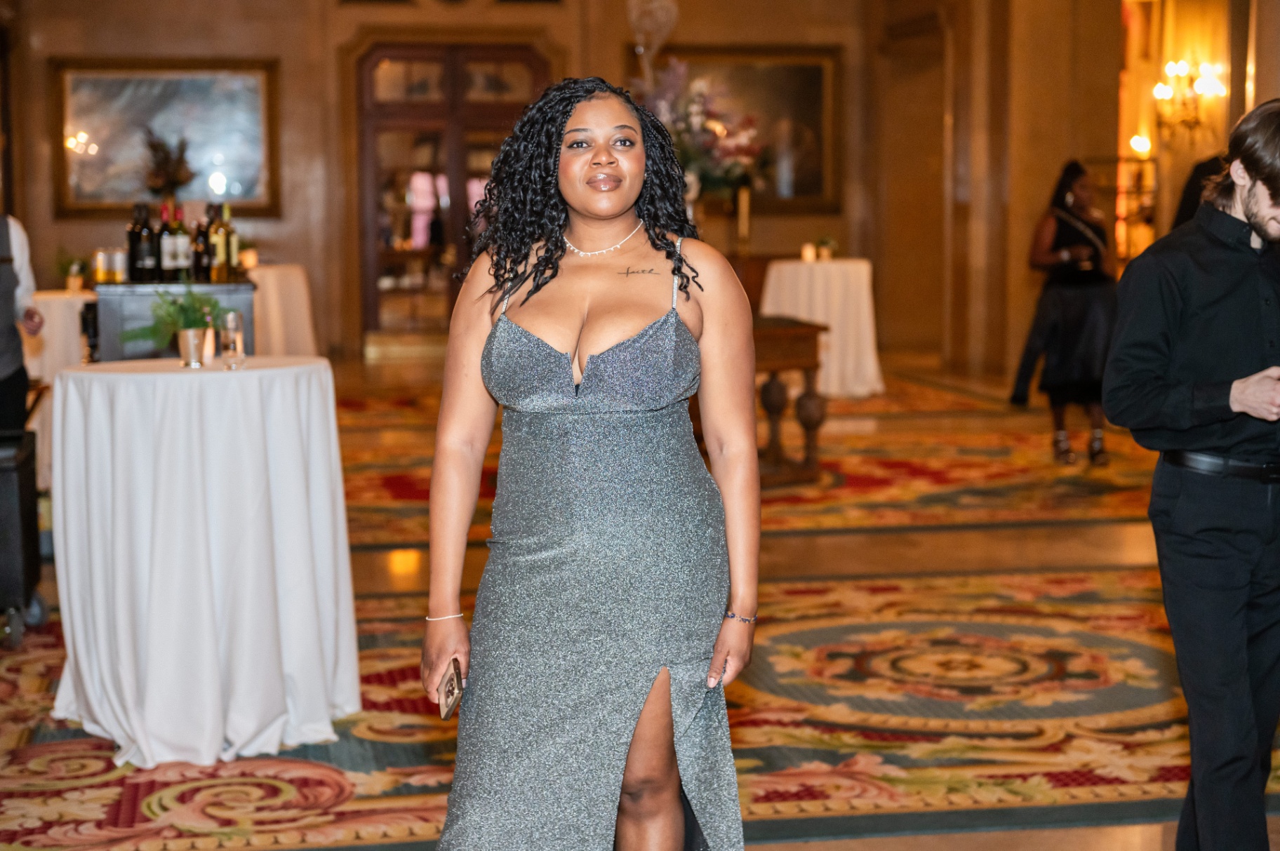 Guest in shimmering silver gown arriving through the Fairmont Château Laurier foyer