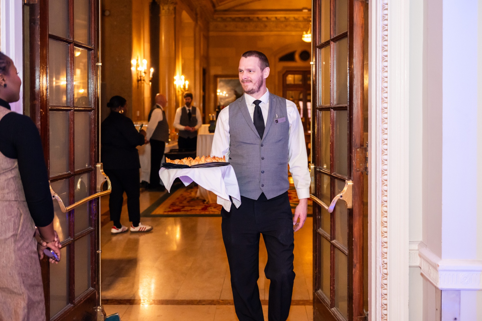 Server carrying hors d'oeuvres through the Fairmont Château Laurier doorway