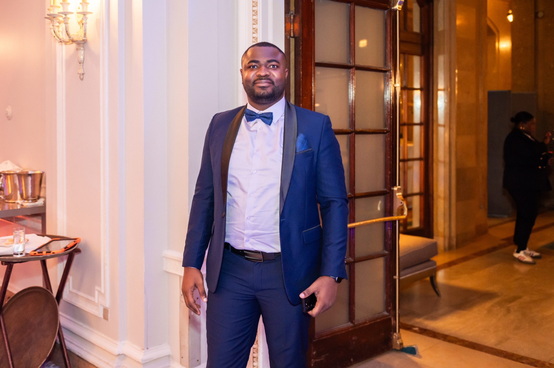 Guest in navy tuxedo standing at the entrance of the Fairmont Château Laurier