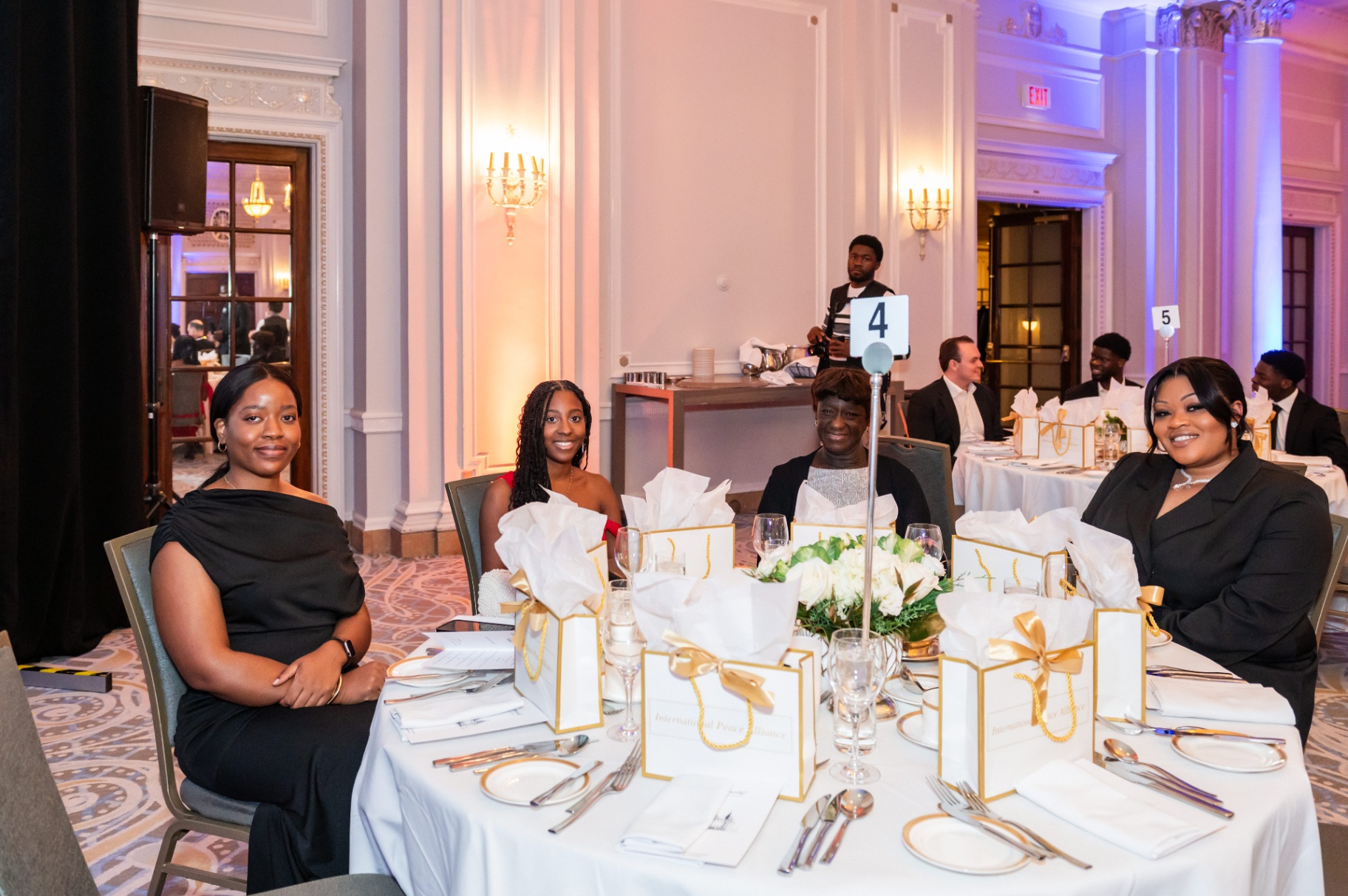Four guests posing together at their table in the Fairmont ballroom
