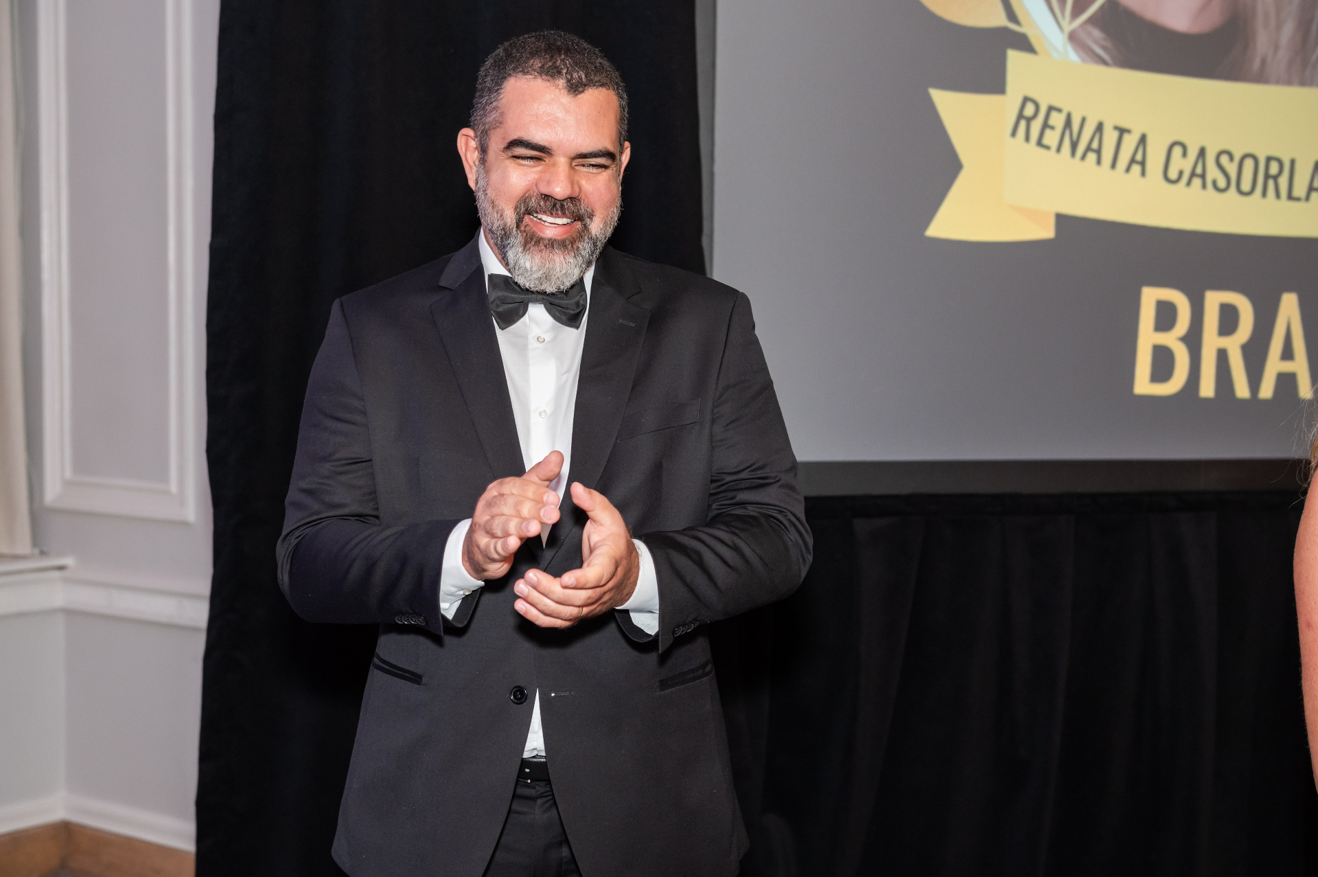 Elias Almeida applauding during the Humanitarian Impact Award ceremony