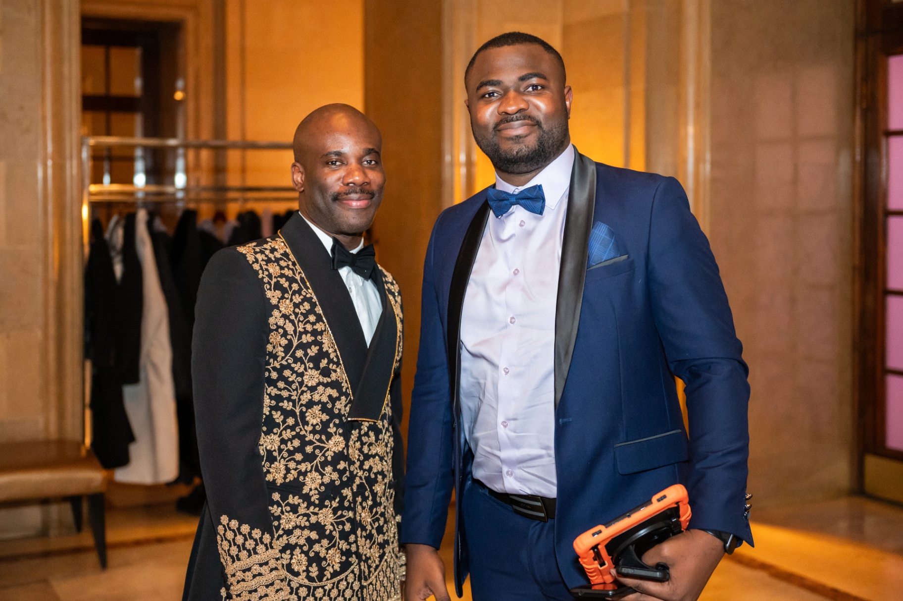 Two gala attendees posing in formal evening wear in the Fairmont foyer