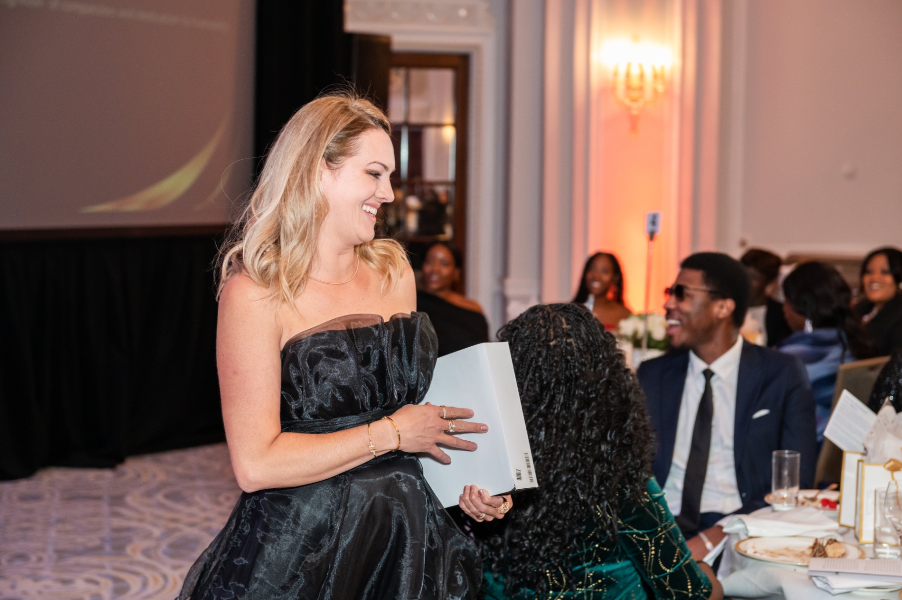 Renata Casorla greeting guests after receiving the Humanitarian Impact Award