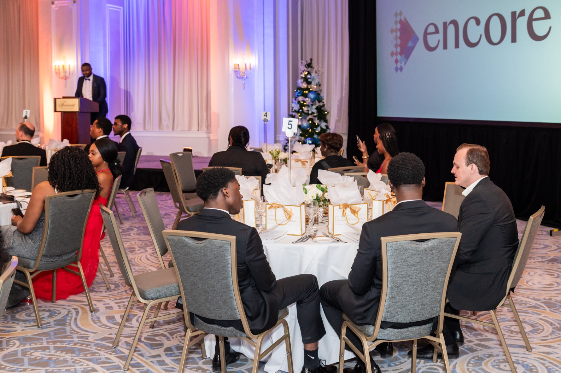 Ballroom view of the gala dinner with the Encore stage screen in the background