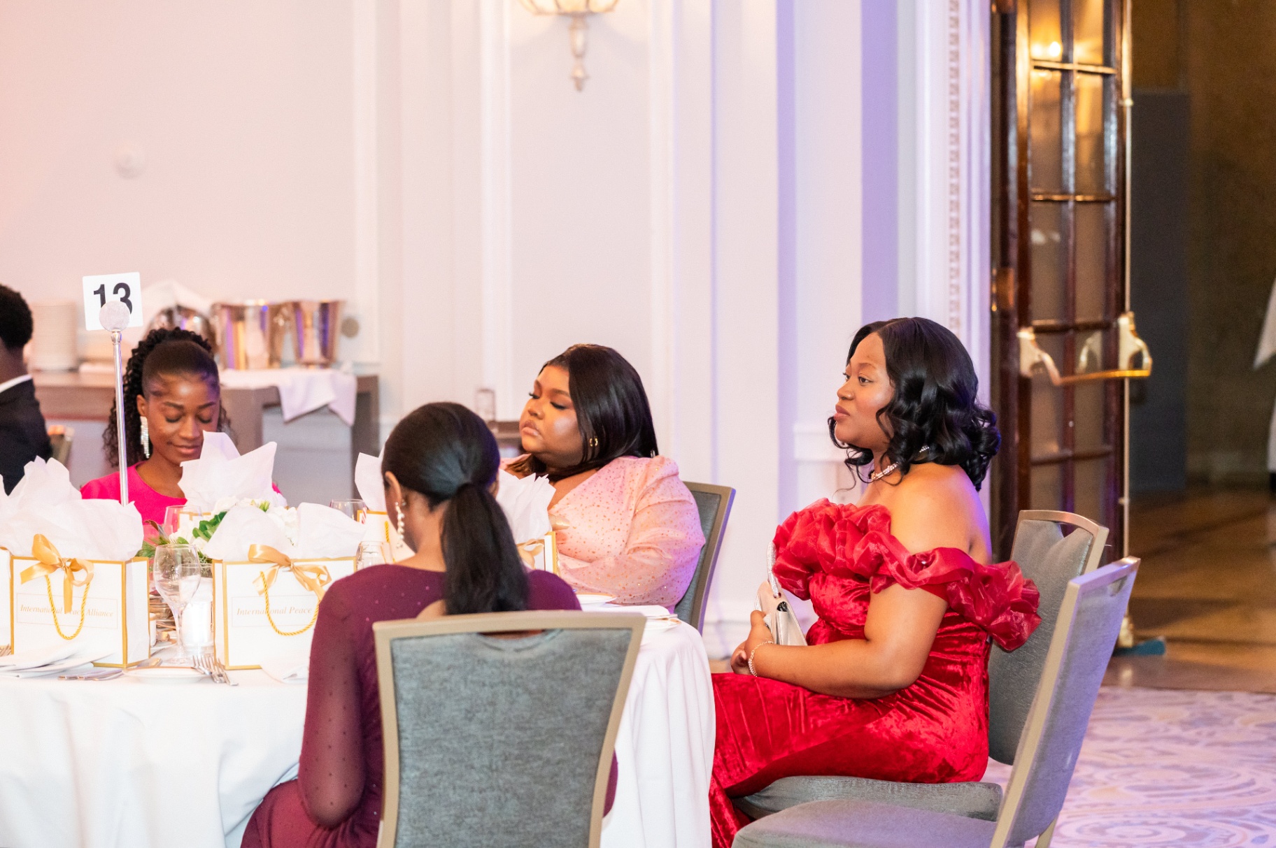 Guests in evening attire seated at table 13 during the gala dinner