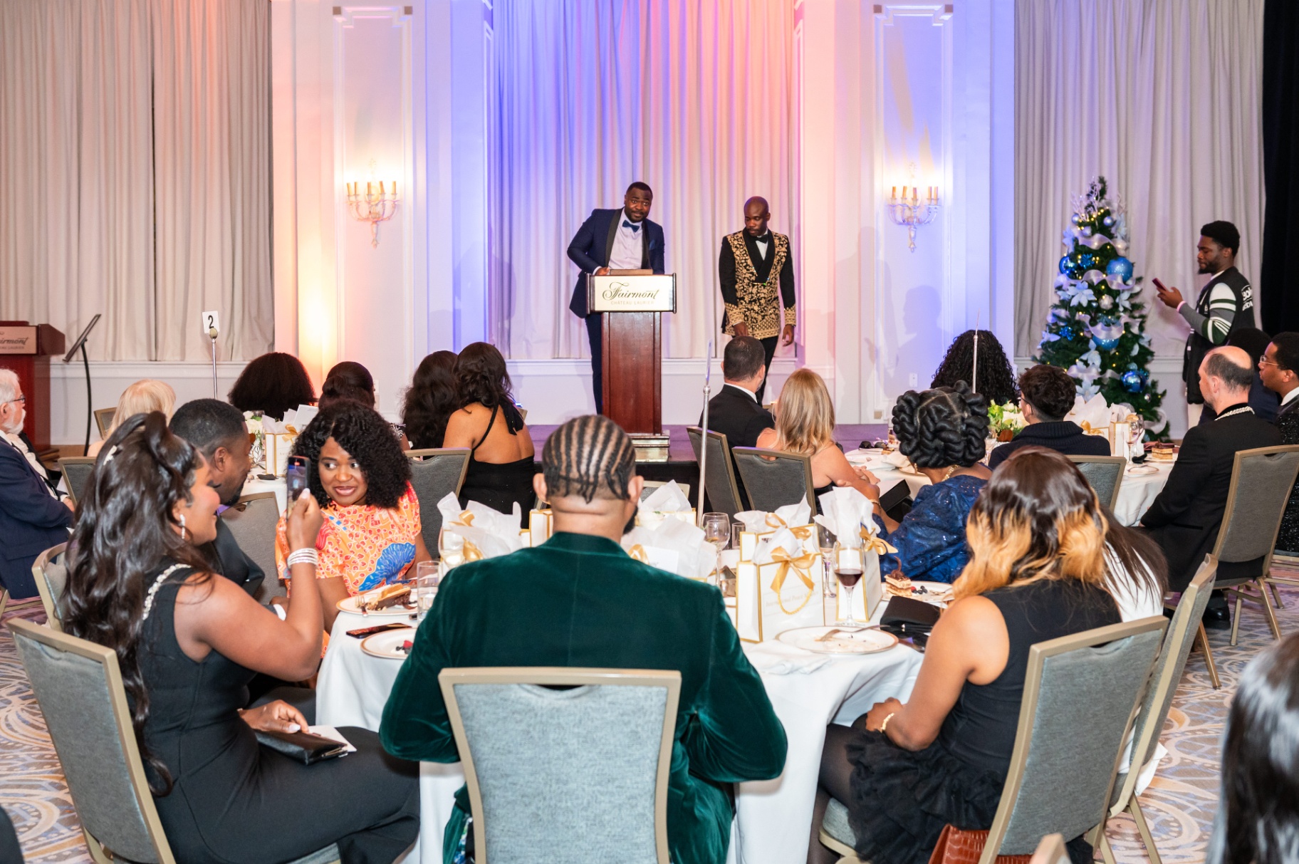 Hosts at the Fairmont Château Laurier podium addressing the room