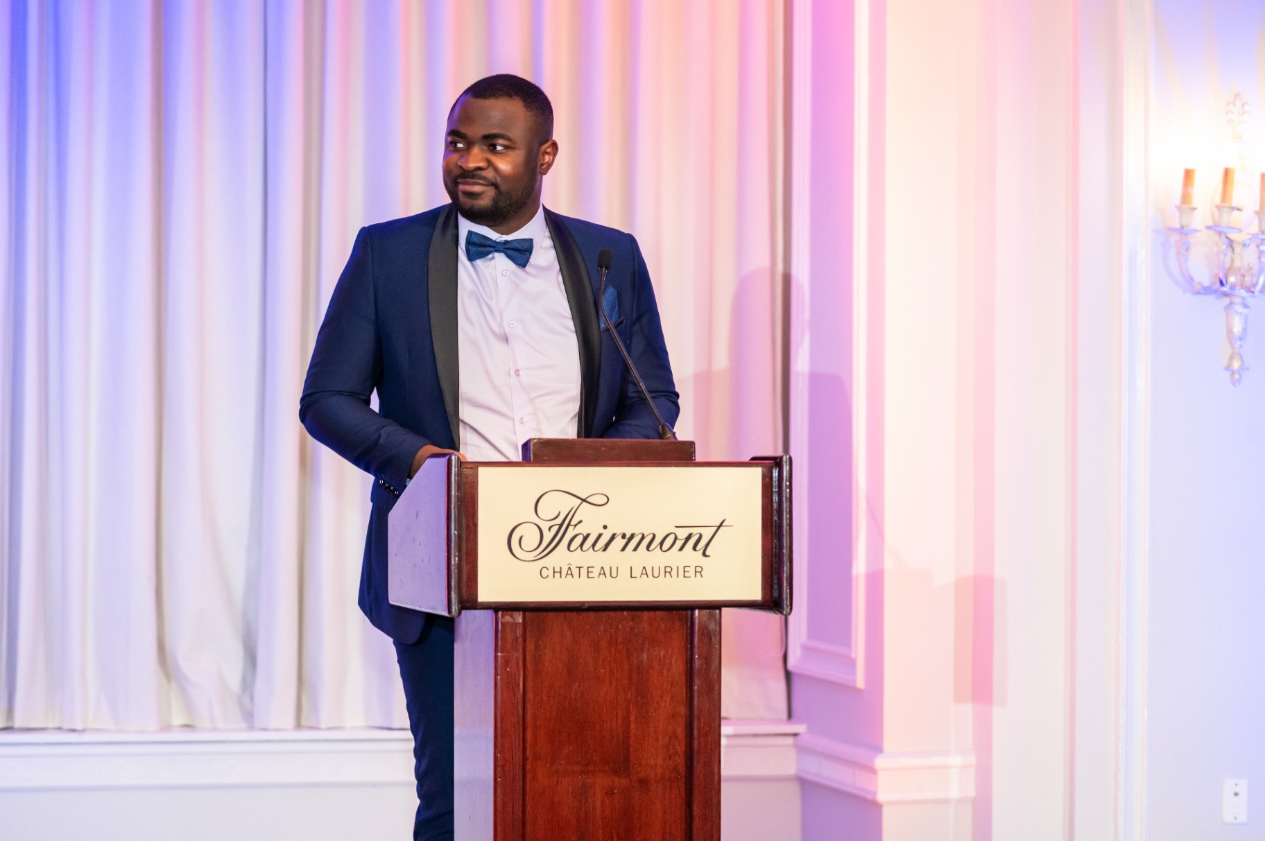 Gala host at the podium during the 2025 Business & Philanthropy Gala Night