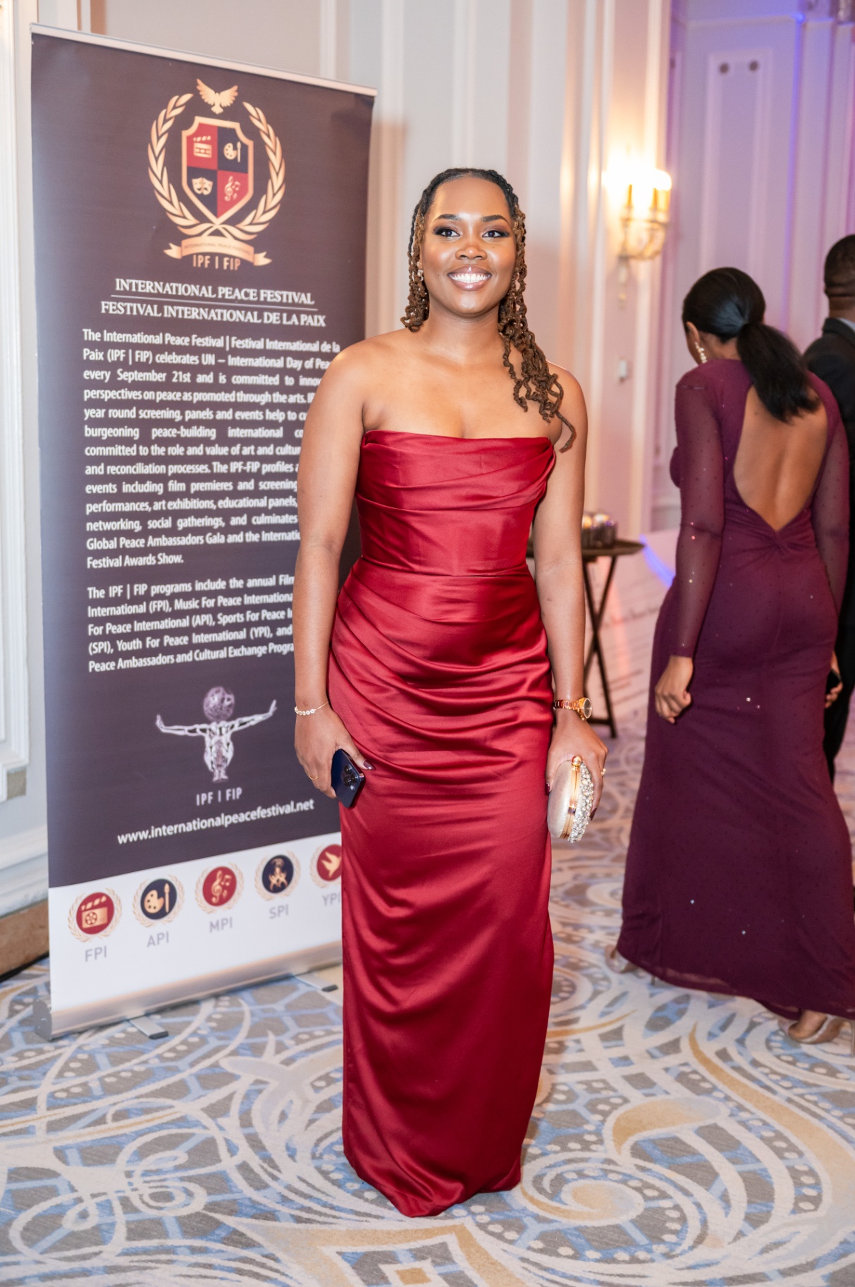 Gala attendee in red evening gown