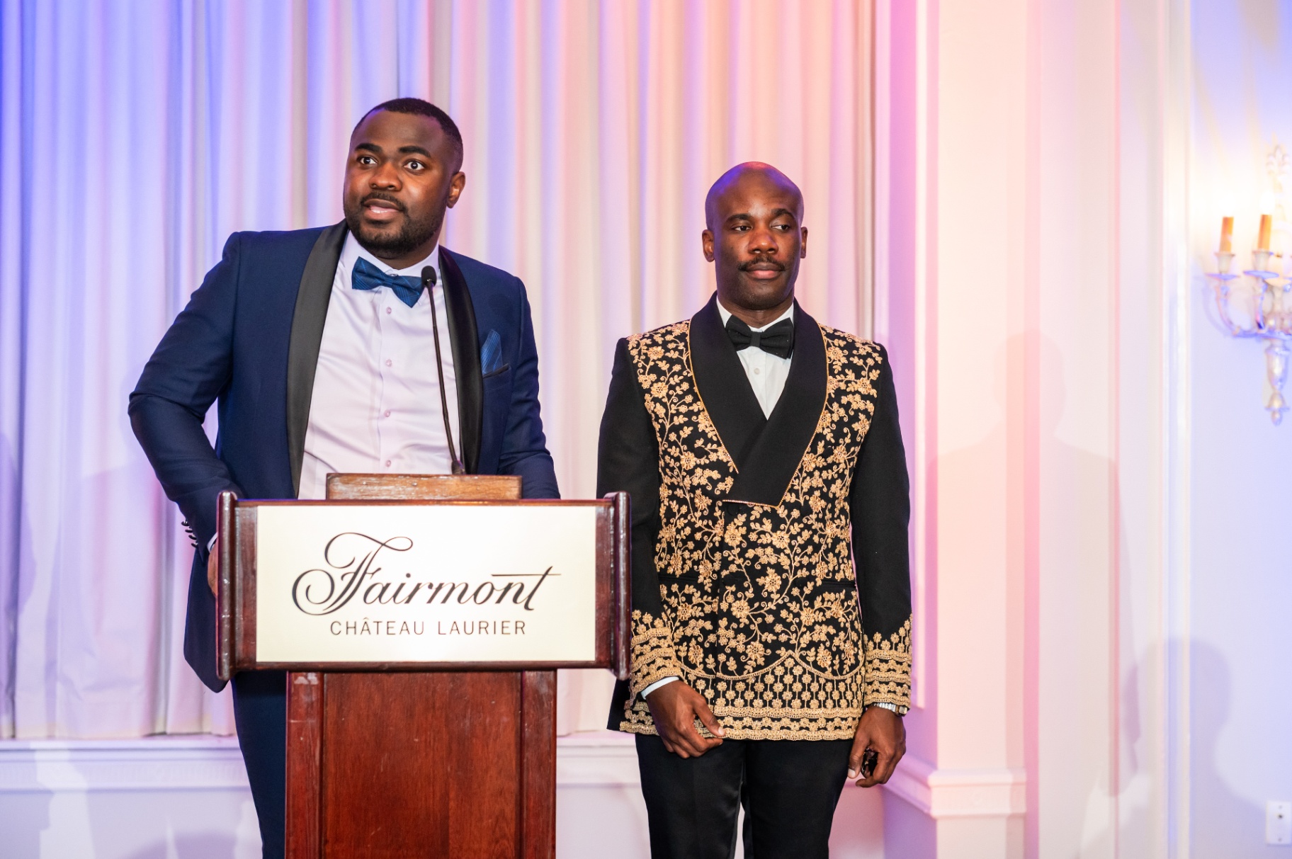 Hosts addressing guests from the Fairmont Château Laurier podium