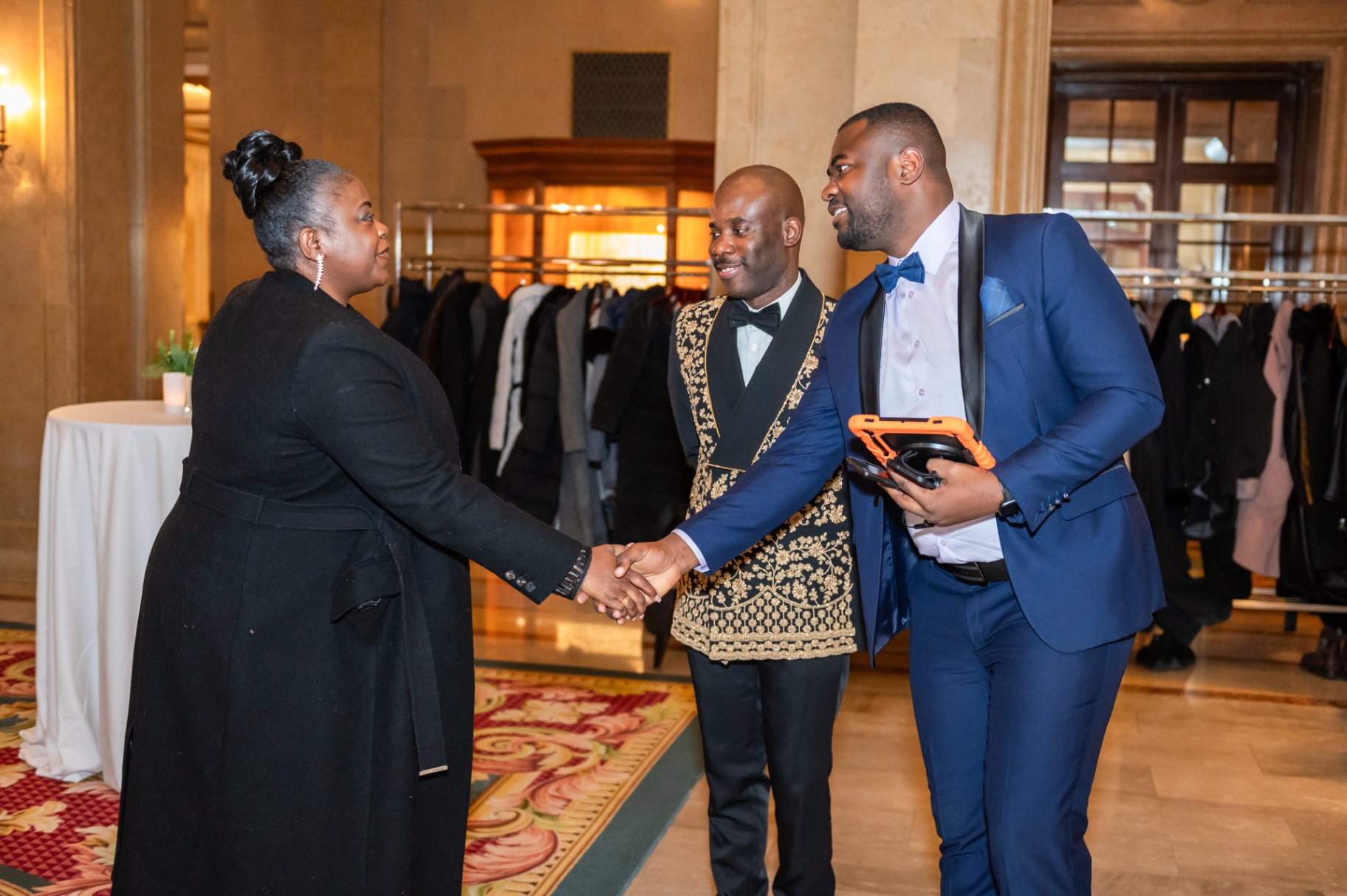 Warm welcome and handshake between arriving guests in the Fairmont foyer