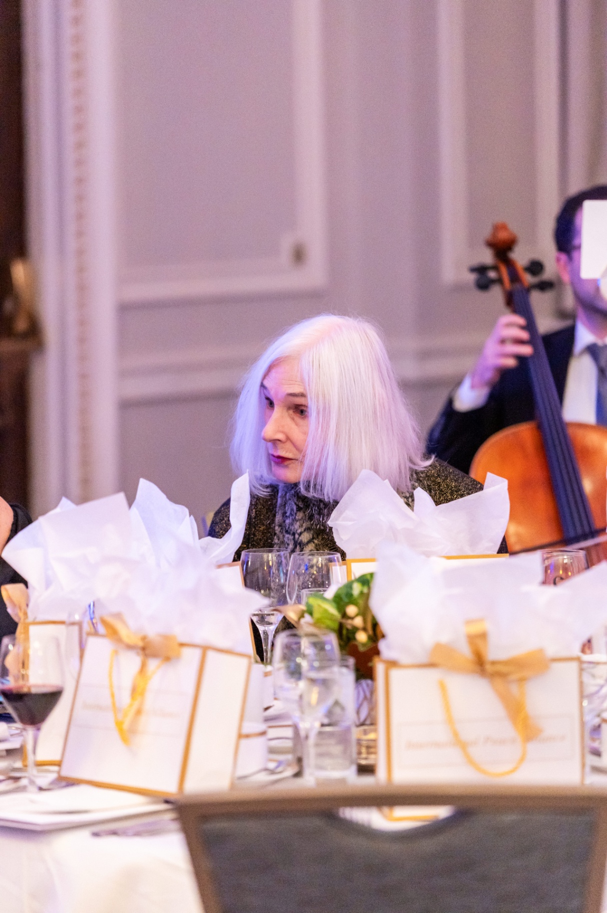 Guest seated during the gala dinner with the live cello performance in the background