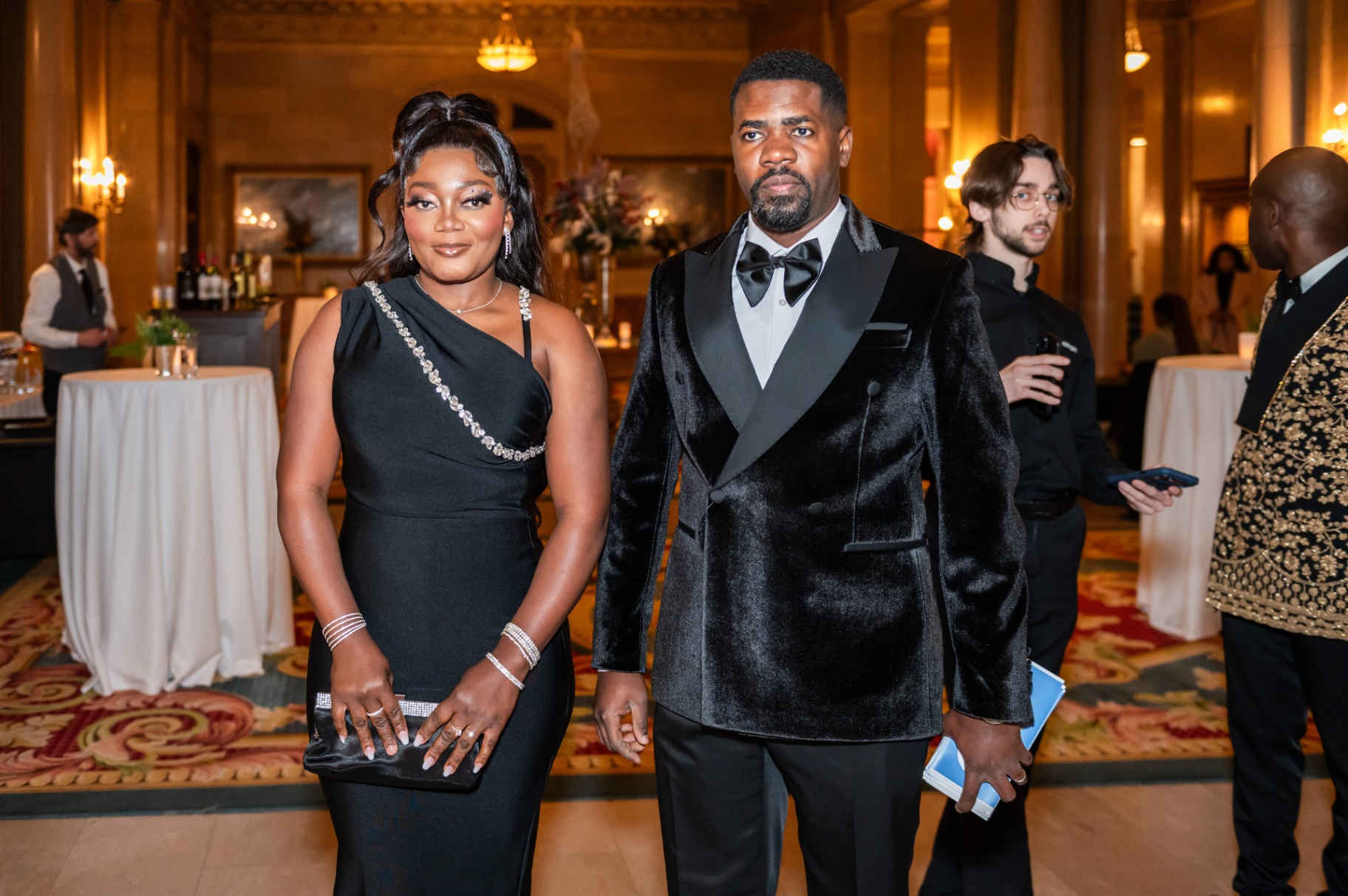 Couple posing in black evening wear and velvet tuxedo at the Fairmont Château Laurier